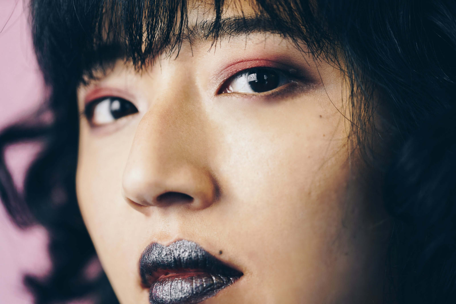 Dark-haired Asian female wearing black lipstick.