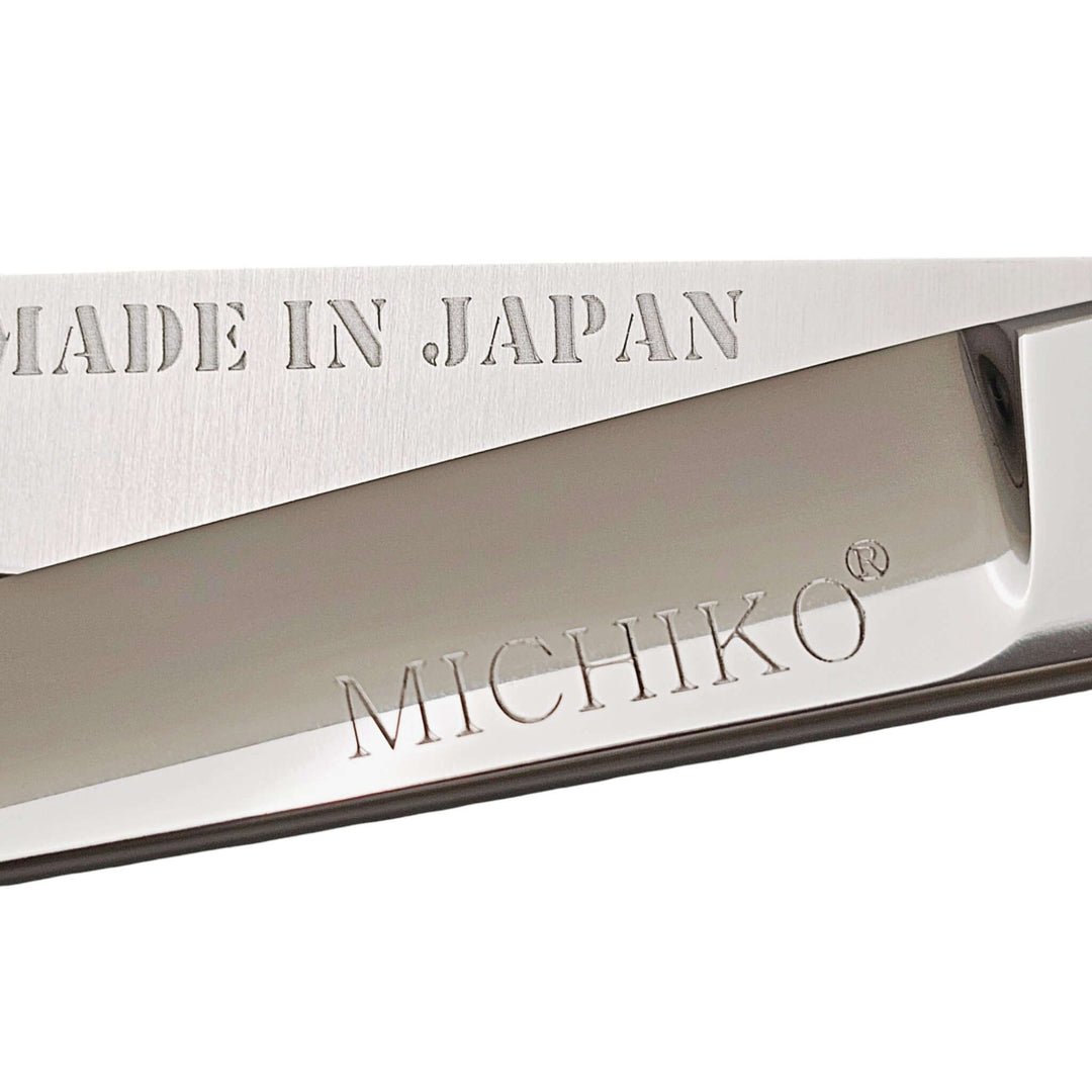 Close-up of Professional Japanese hair cutting shears showing engraved 'Made in Japan' and 'MICHIKO' logos.