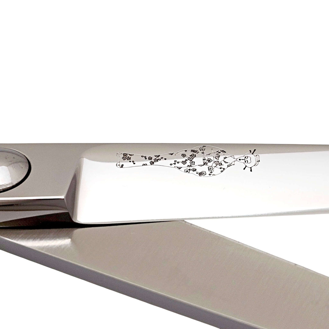 Close-up of Professional Japanese hair cutting shears showcasing the intricate design on the handle.