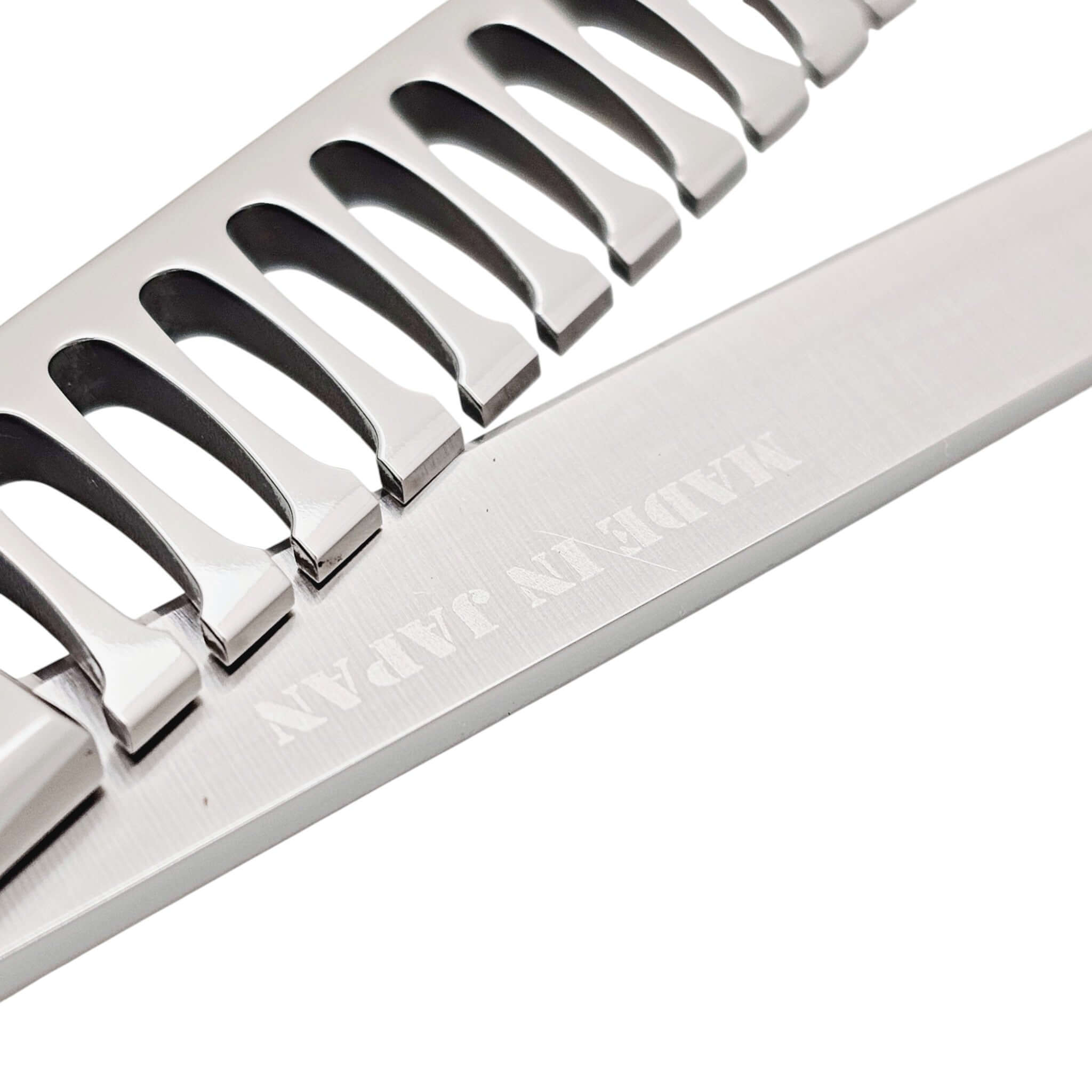 Close-up of hair texturizing shears with engraved 'Made in Japan' text on a white background