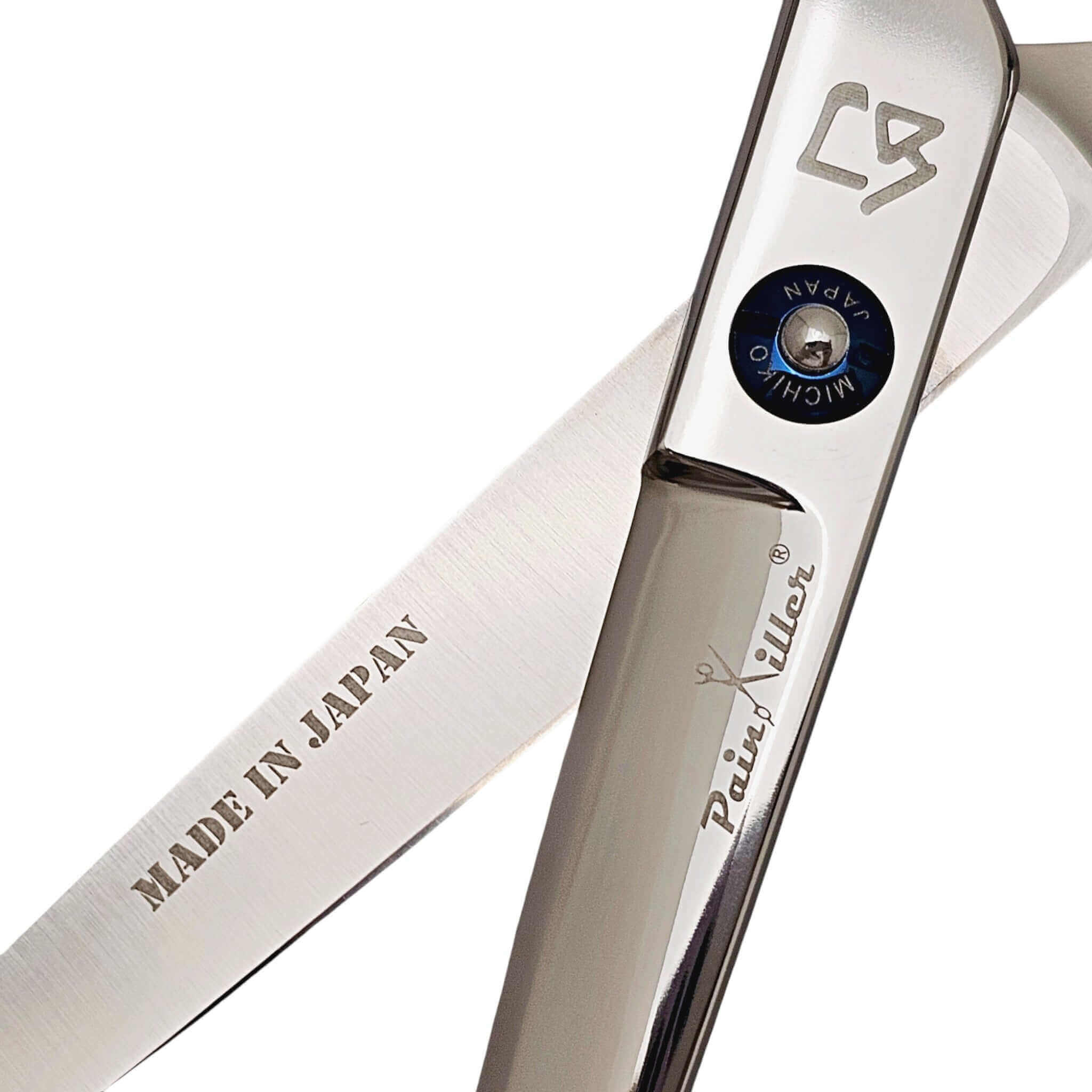 Close-up of a pair of swivel hair scissors with 'Made in Japan' and 'PainKiller' branding on a white background.