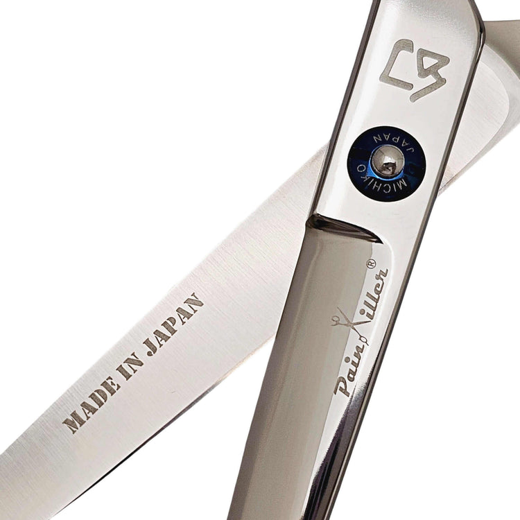 Close-up of a pair of swivel hair scissors with 'Made in Japan' and 'PainKiller' branding on a white background.