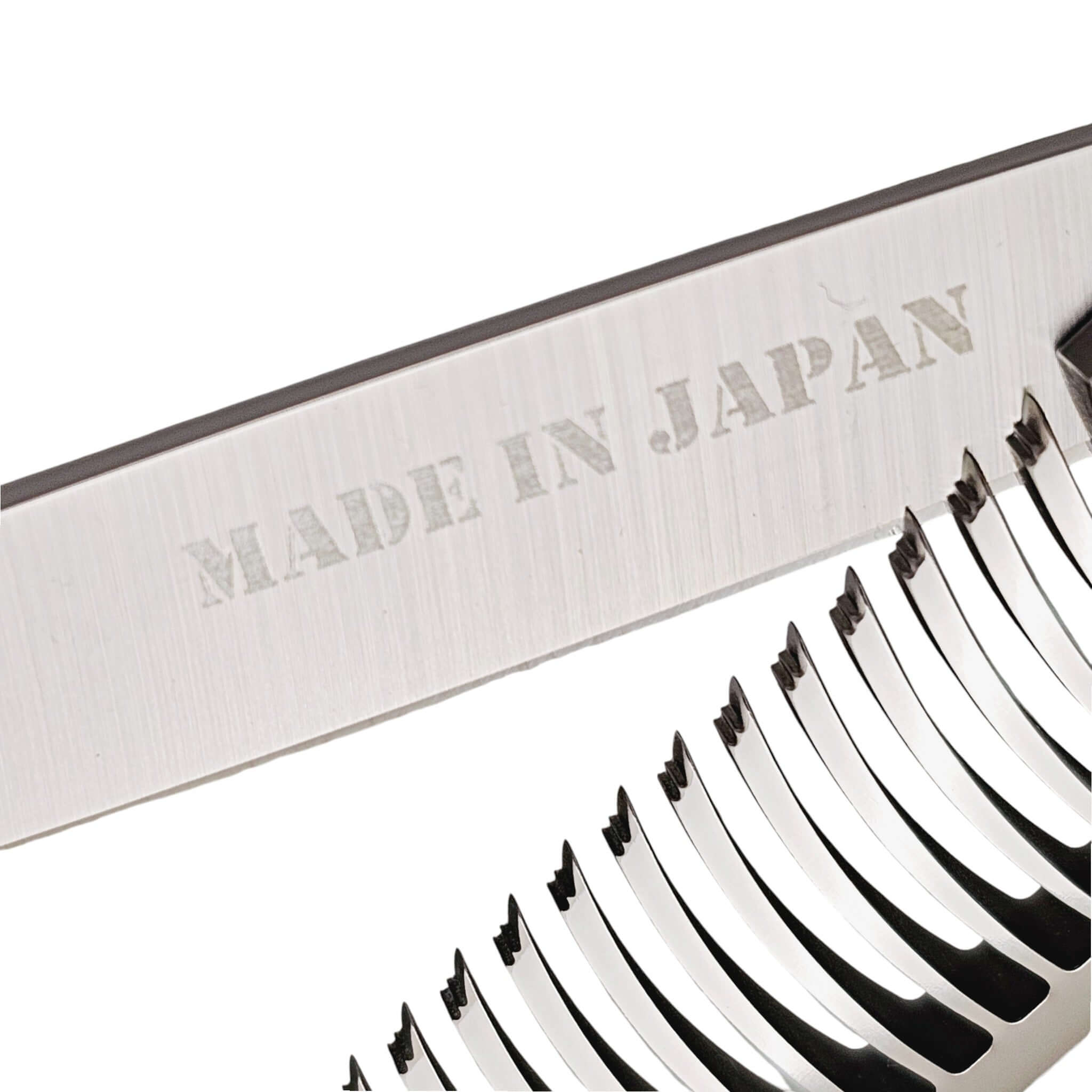Close-up of hair thinning shears with a 'Made in Japan' label on a white background