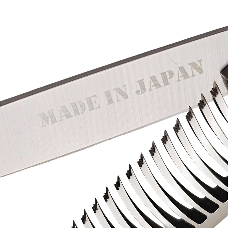 Close-up of hair thinning shears with a 'Made in Japan' label on a white background