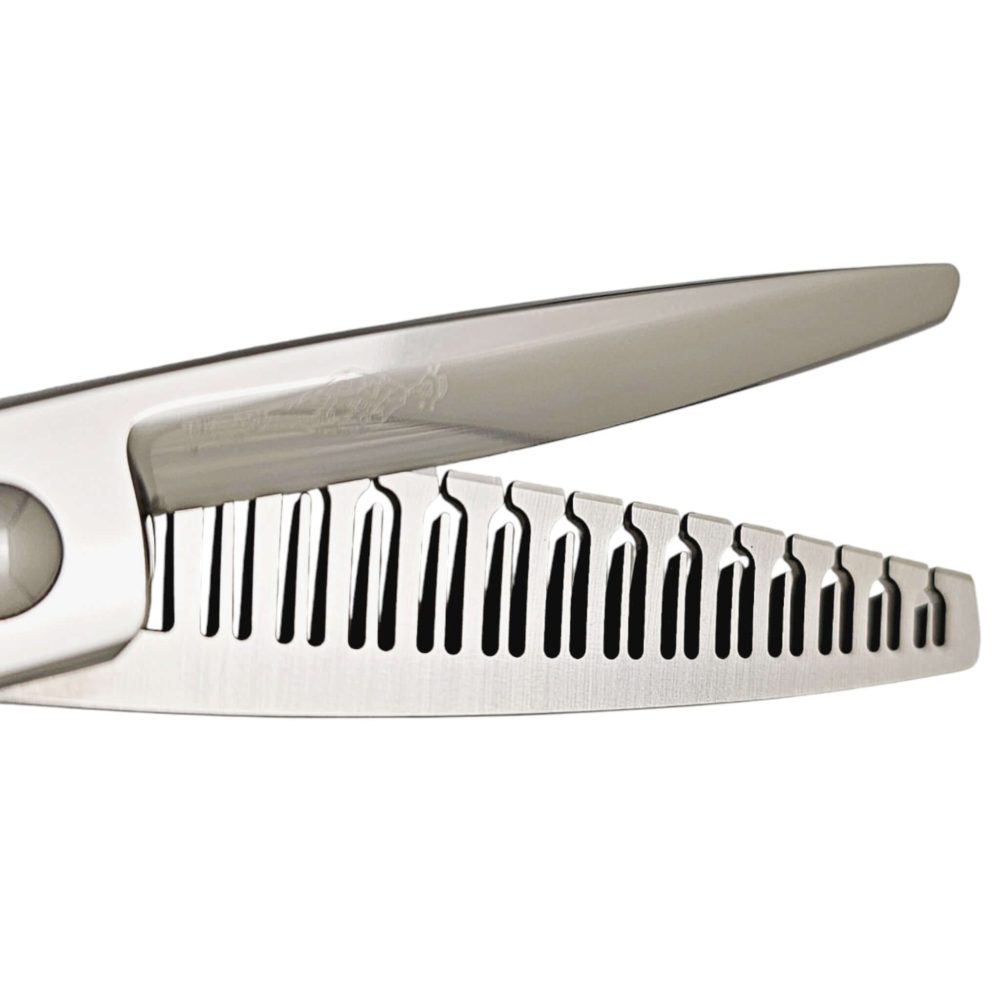 Close-up of a pair of hairdressing scissors with a comb-like texture on a white background