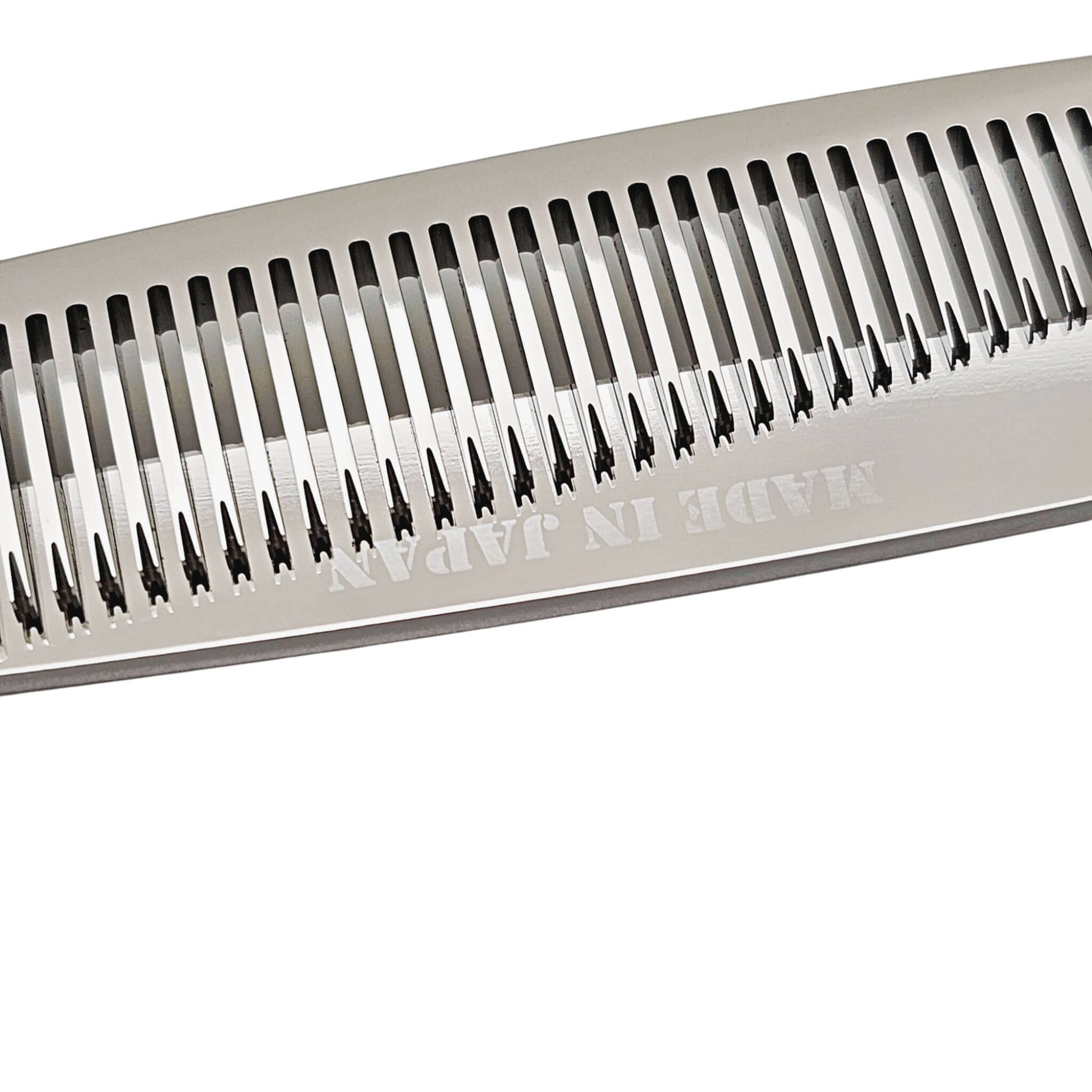 Close-up of thinning blade of hair shears with 'Made in Japan' text on a white background