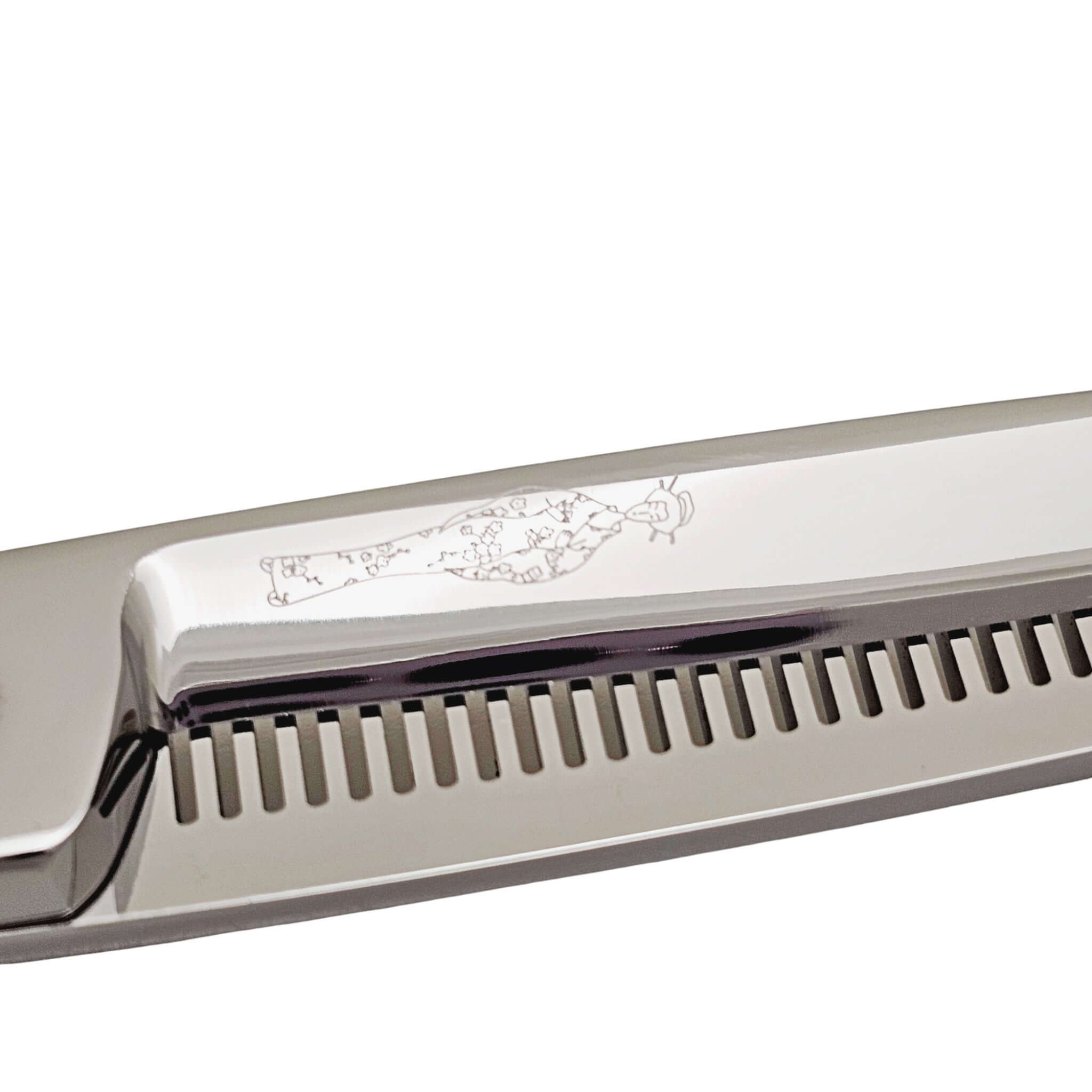 Close-up of hair thinning shears with engraved Japanese lady design on a white background