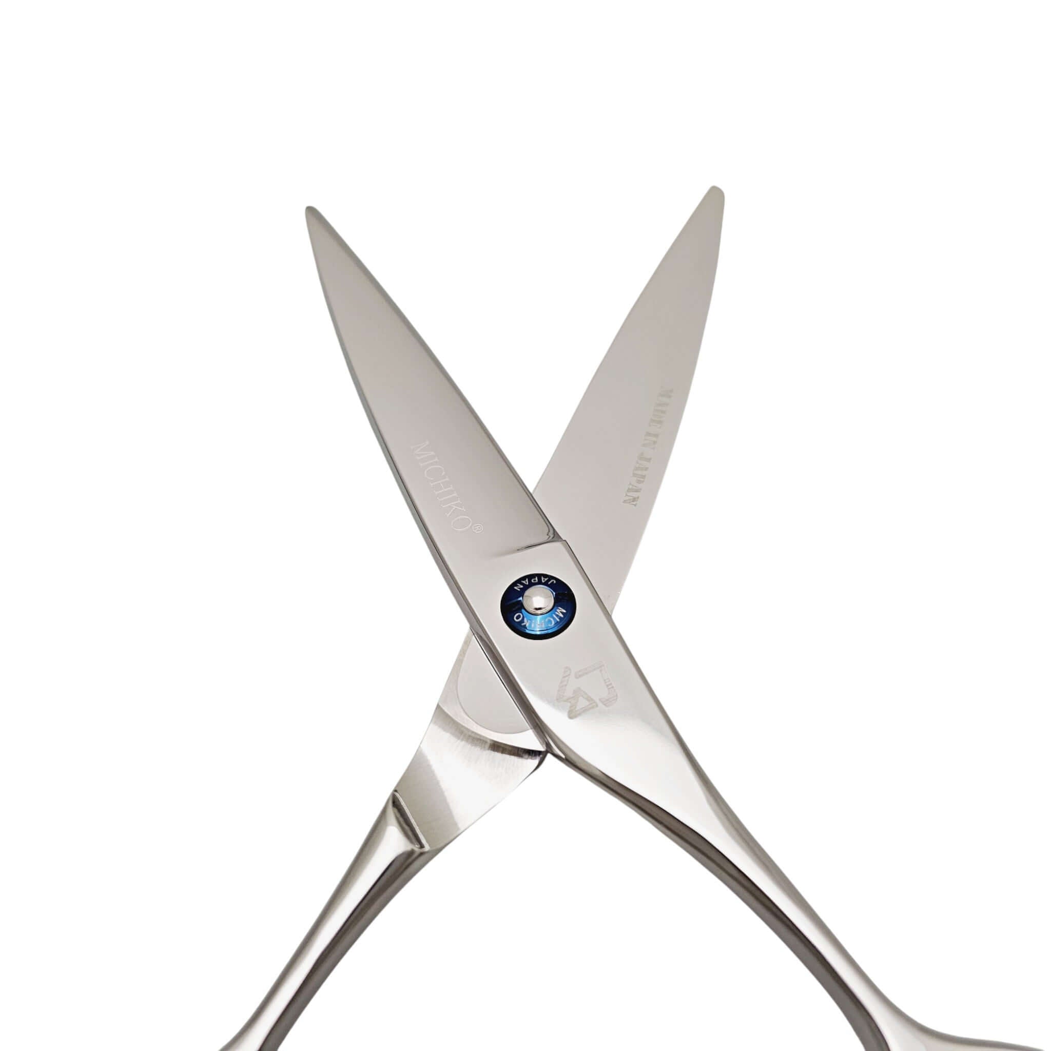 Pair of silver barber scissors on a white background