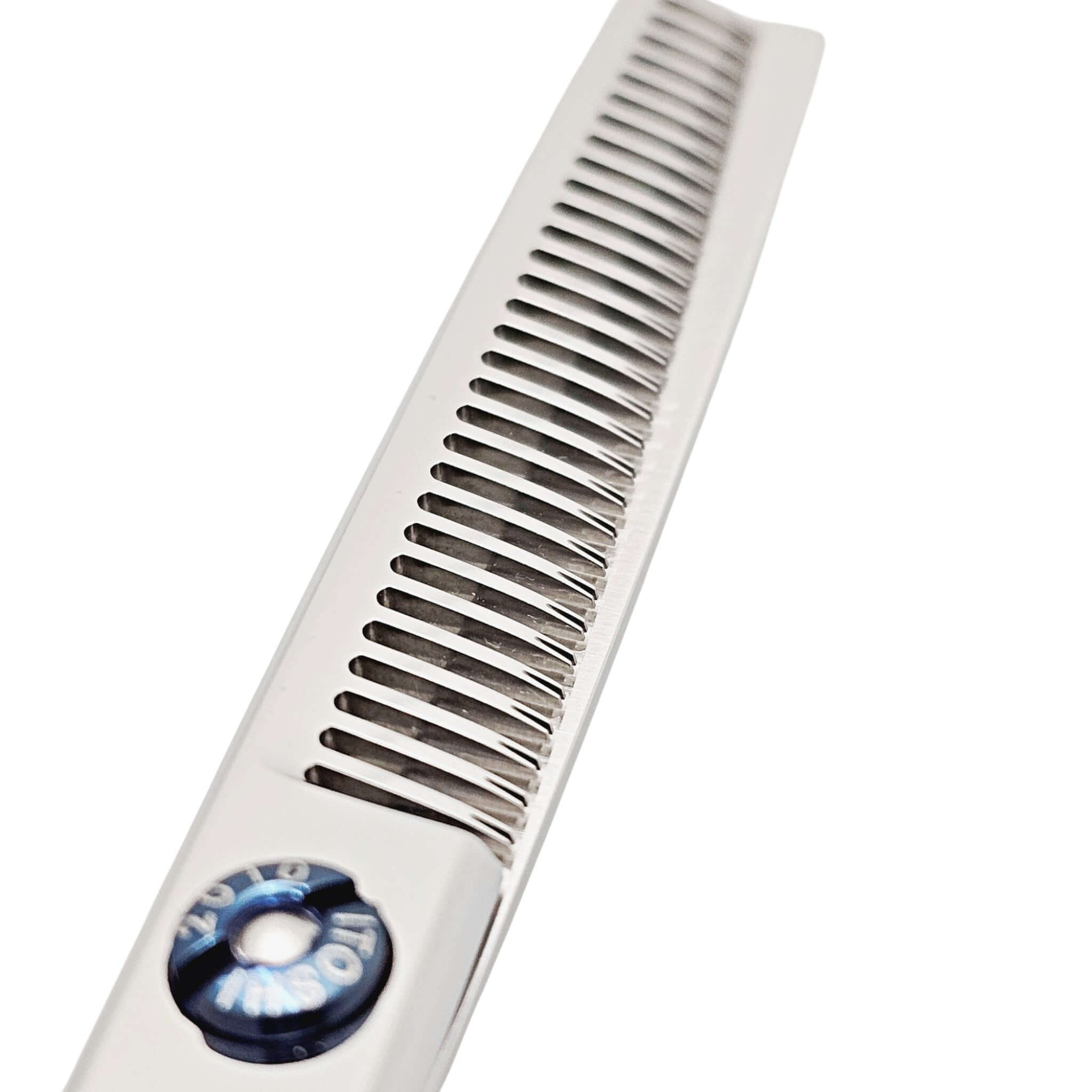 Metal teeth from the hair thinning shears on a white background