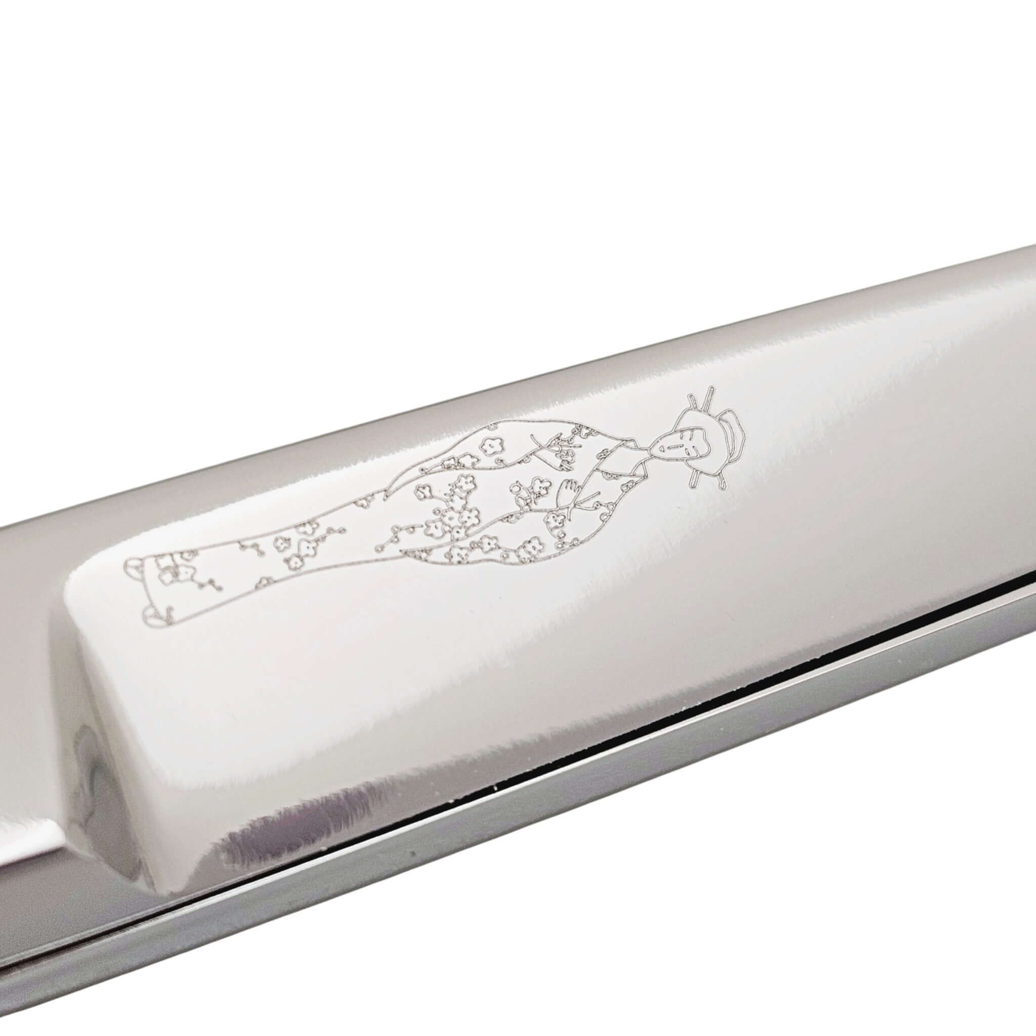 Silver hair scissor blade with engraved Japanese lady wearing kimono design on a white background