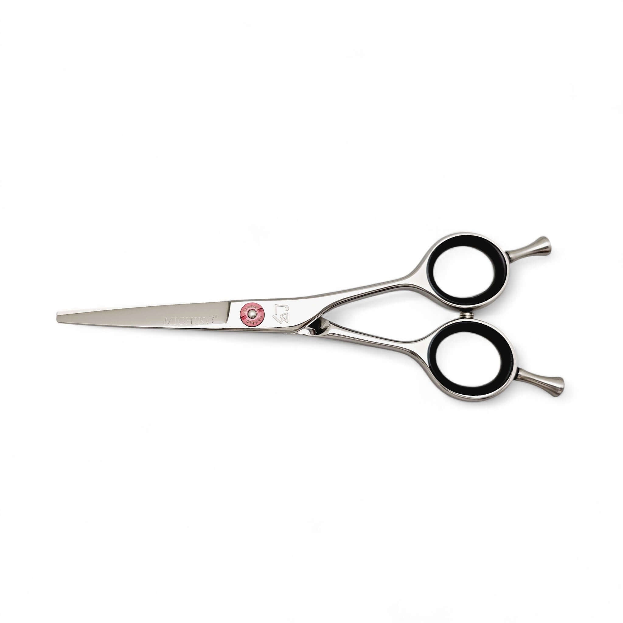 Hair cutting scissors with pink screw on a white background