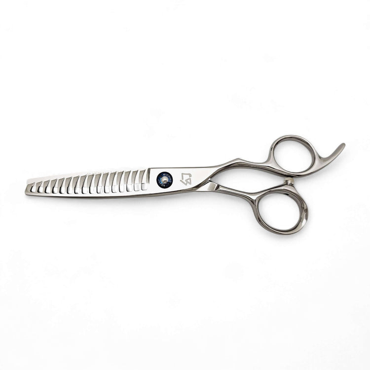 Stainless steel hair thinning scissors on a white background