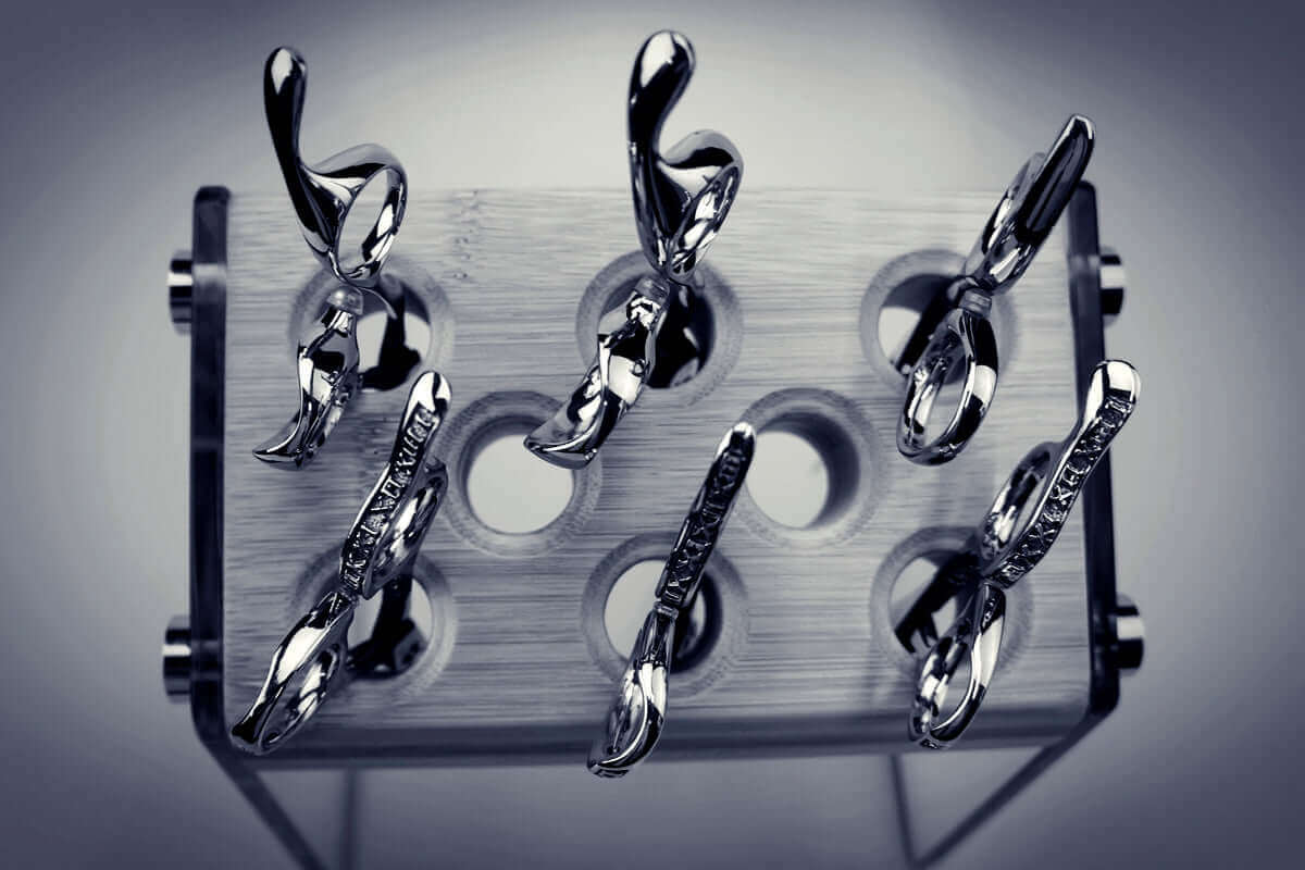 Barber shears displayed on a wooden holder, exploring The Hidden Reason Some Barber Shears Die After Sharpening.