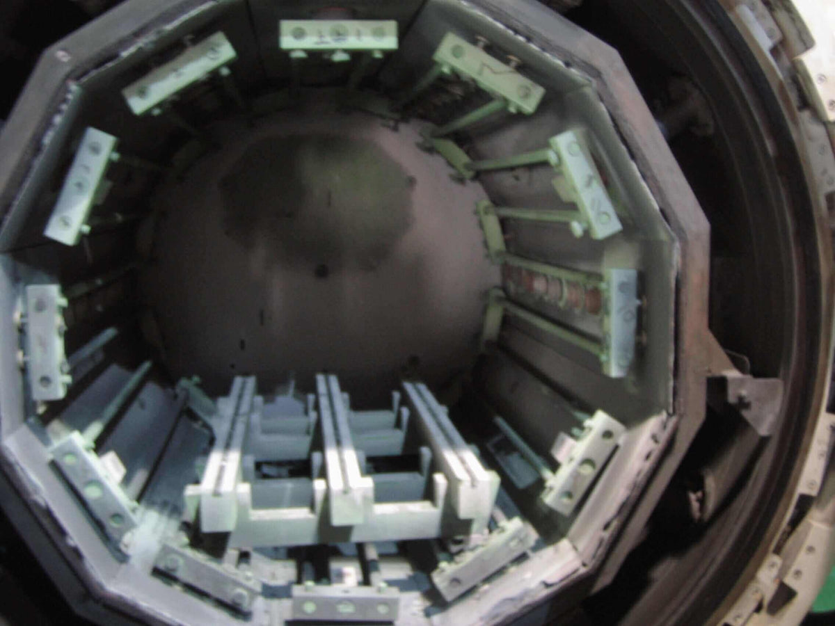 Open furnace showing internal chamber used for heat treatment of professional hair cutting scissors.