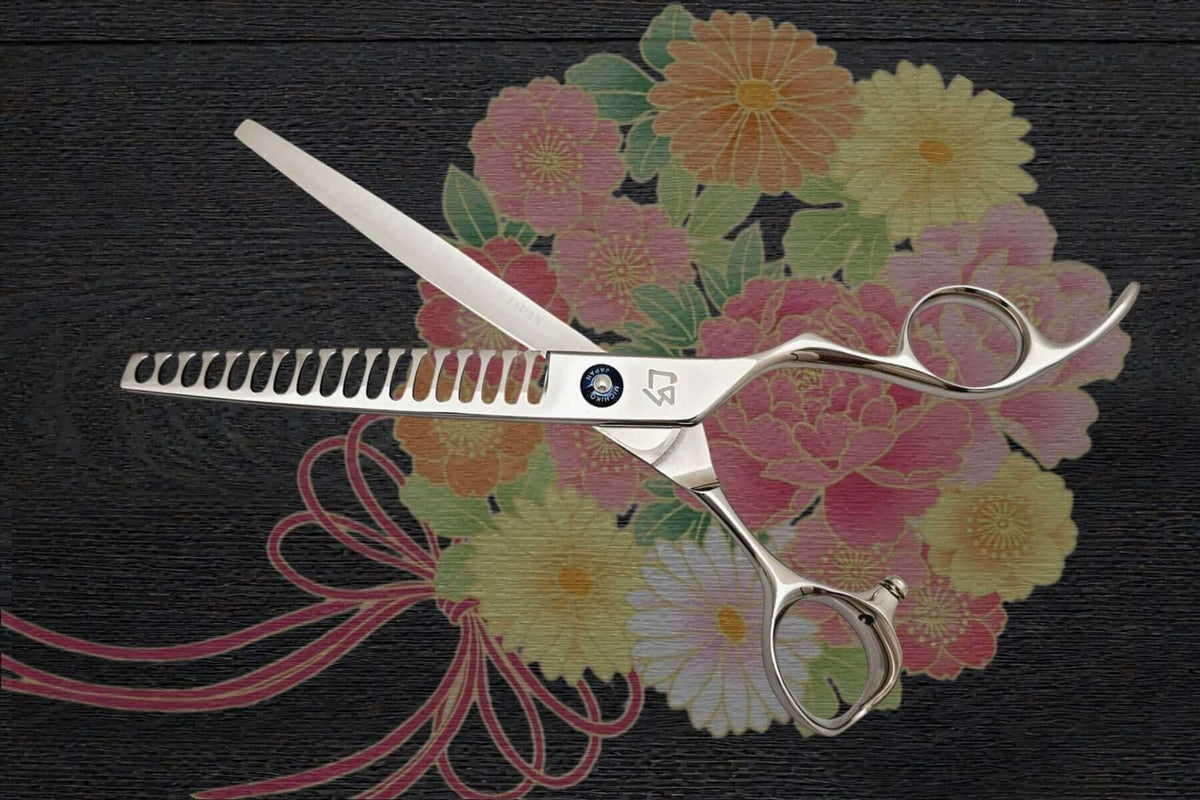Japanese scissors placed on a floral background, showcasing their design and craftsmanship. Why Do Japanese Scissors Still Hold Value.
