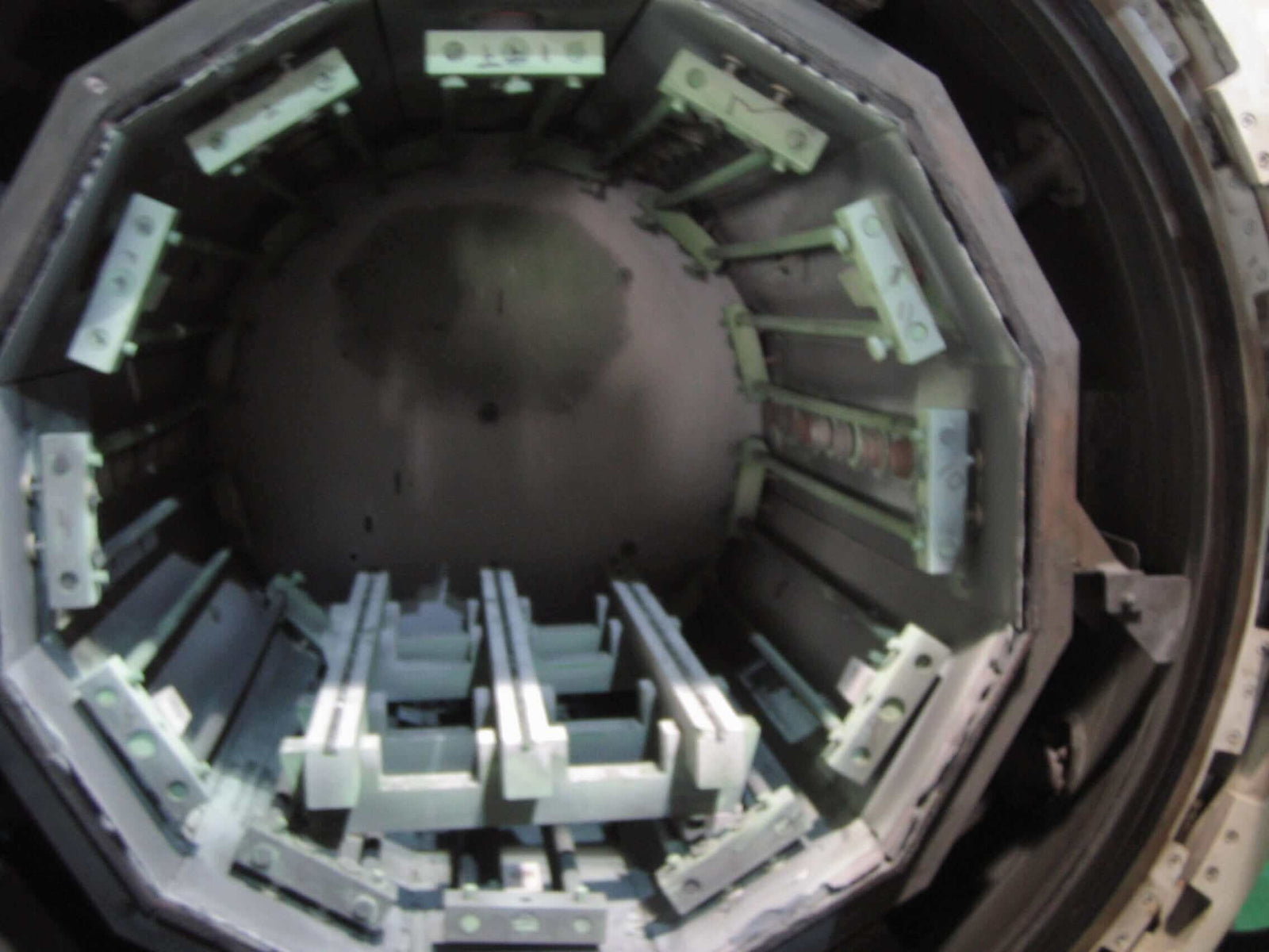 Open furnace showing internal chamber used for heat treatment of professional hair cutting scissors.