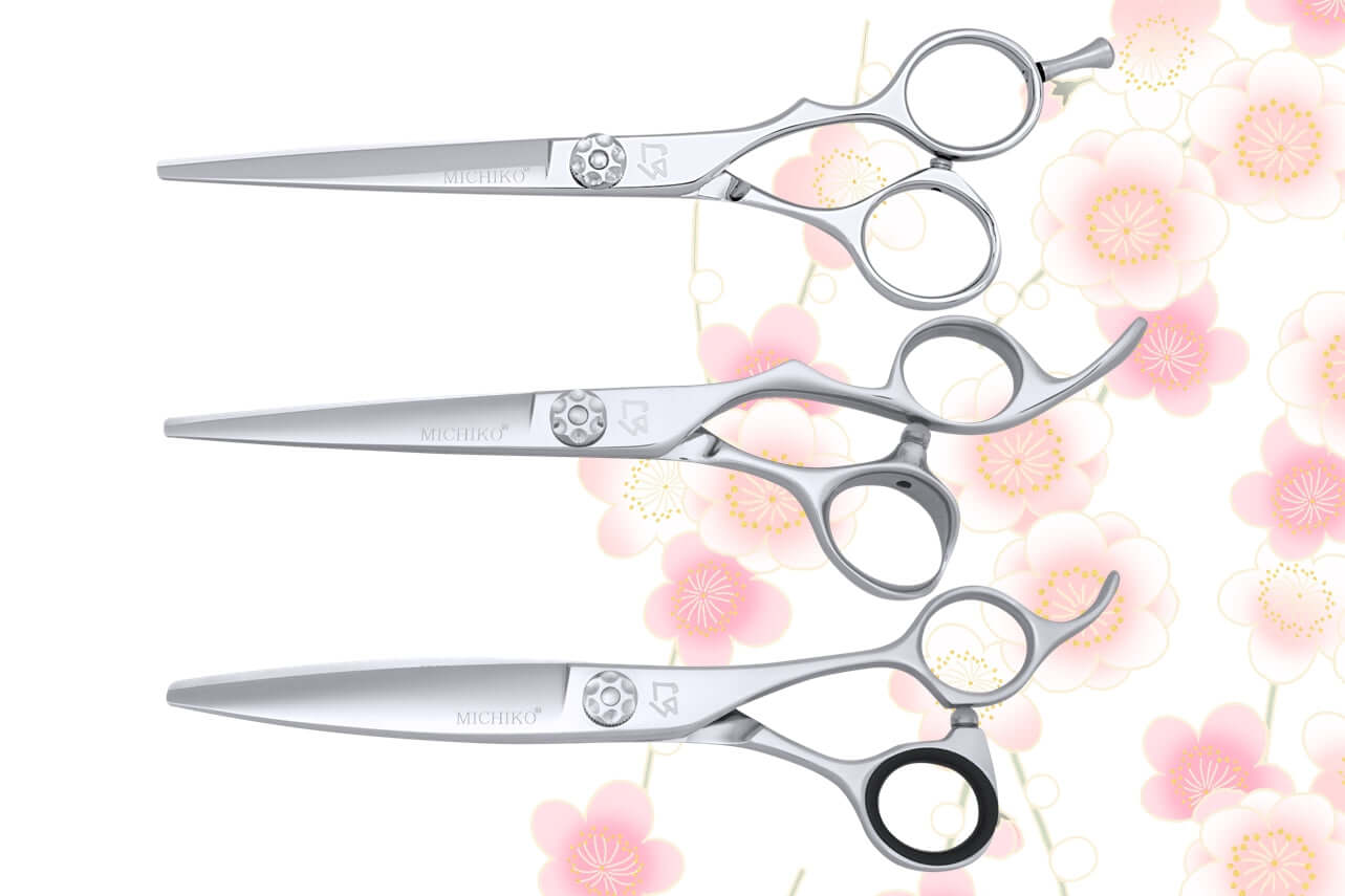 Premium Michiko hair cutting scissors – ergonomic Japanese-style professional shears with offset handles, crane design, and precision tension dial, displayed on a floral background for hairstylists and salon professionals.