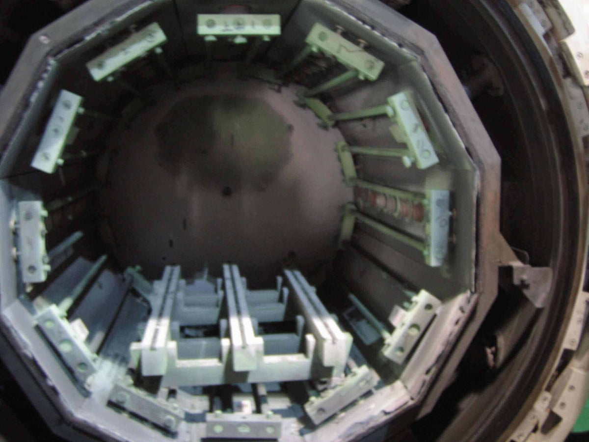 Open furnace showing internal chamber used for heat treatment of professional hair cutting scissors.
