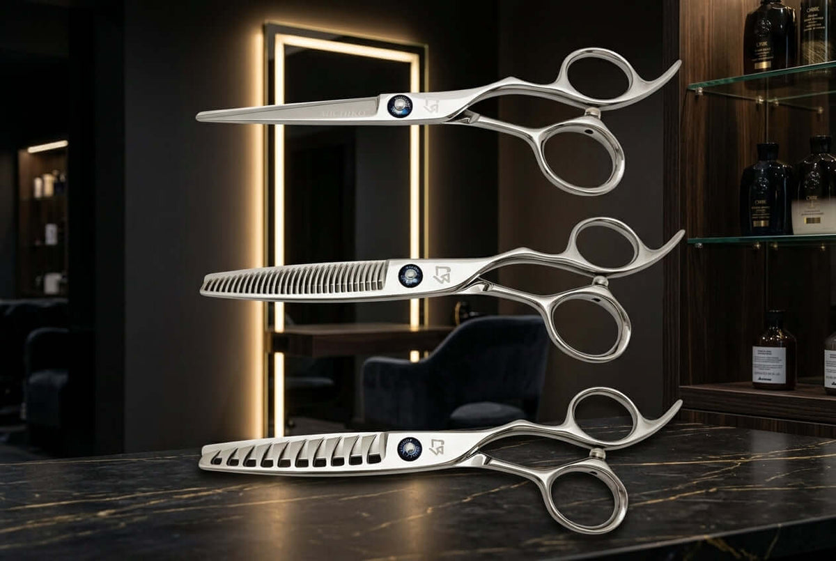 Three professional Michiko hair shears displayed in a high-end salon with dark mood lighting and warm illuminated mirror accents.