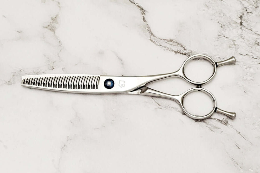 Hair thinning shears on a marble surface