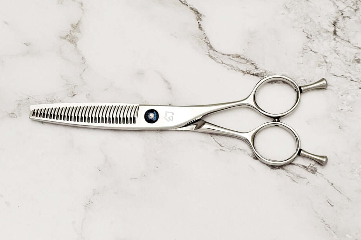 Hair thinning shears on a marble surface