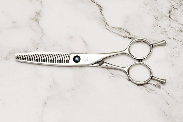 Hair thinning shears on a marble surface