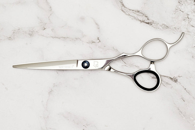 Hair scissors on a marble surface