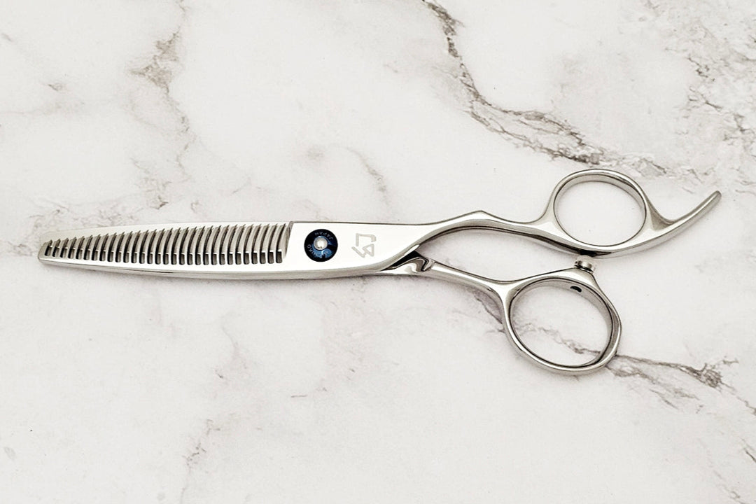 Hair cutting scissors on a marble surface