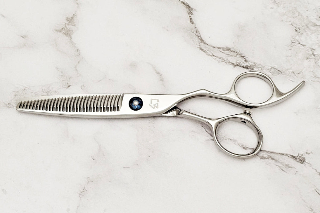 Hair cutting scissors on a marble surface