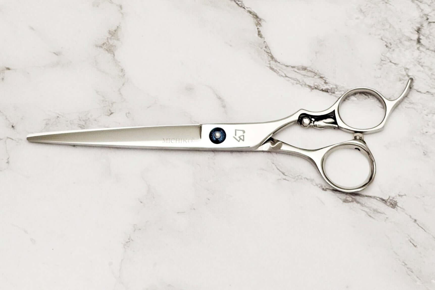 Cat handle barber shears on a marble surface