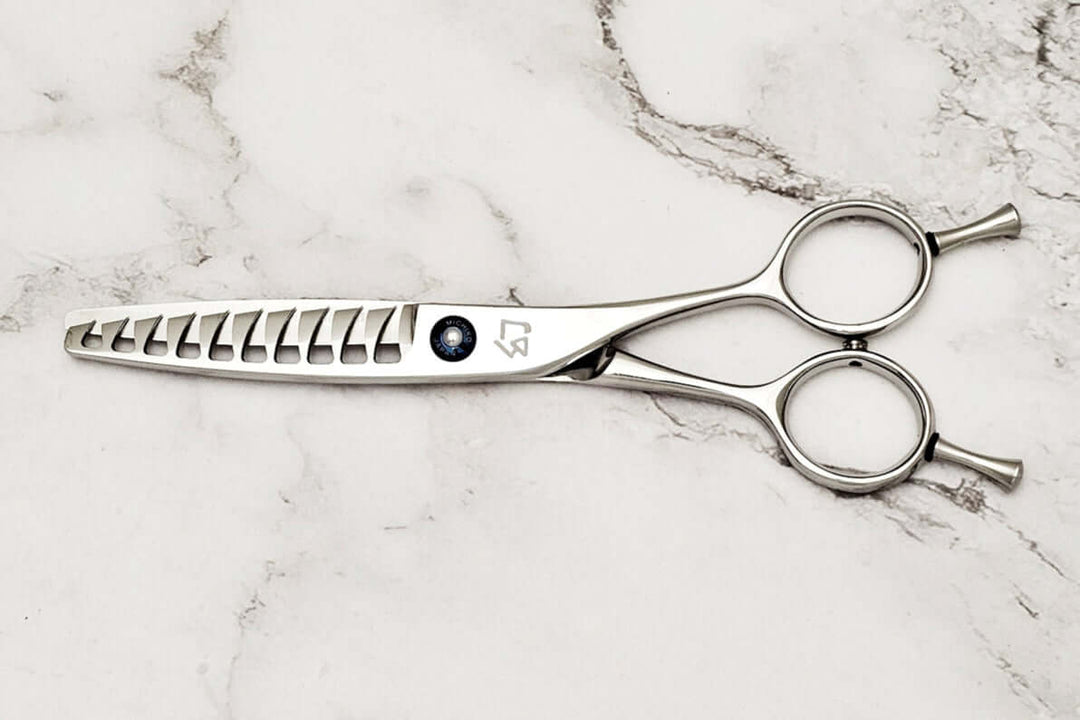 Reversible hair texturizing scissors on a marble surface