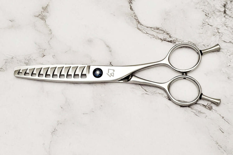 Reversible hair texturizing scissors on a marble surface