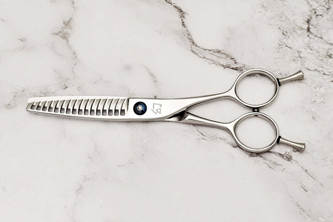 Reversible hair texturizing shears on a marble surface