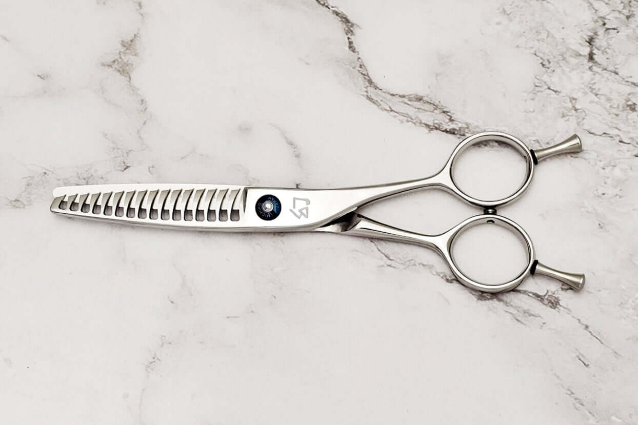 Reversible hair texturizing shears on a marble surface
