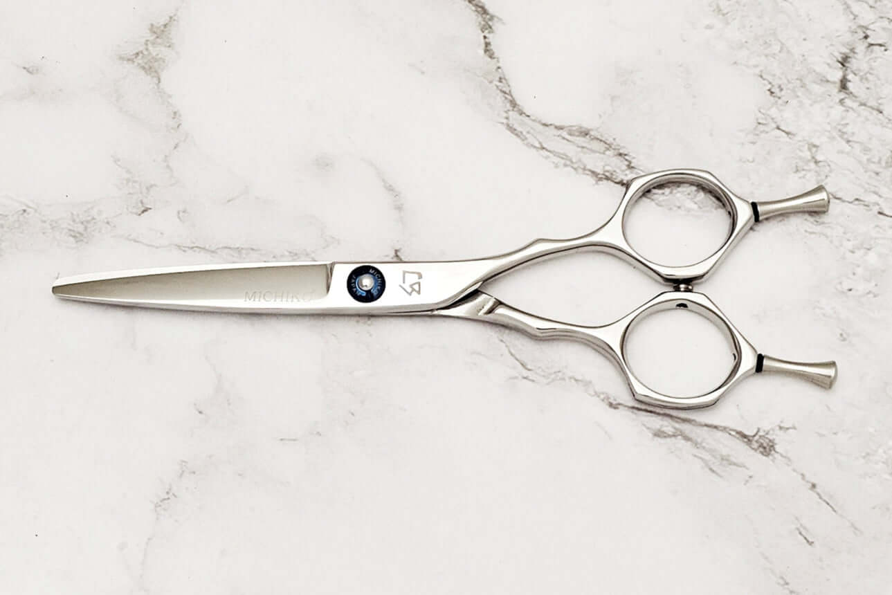 Hair scissors on a marble surface