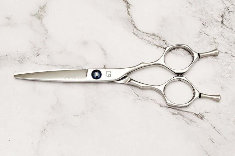 Hair scissors on a marble surface