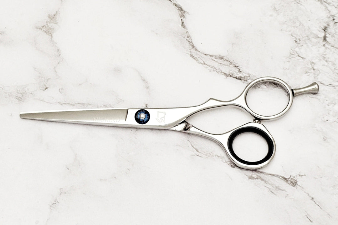 Hair cutting shears on a marble surface