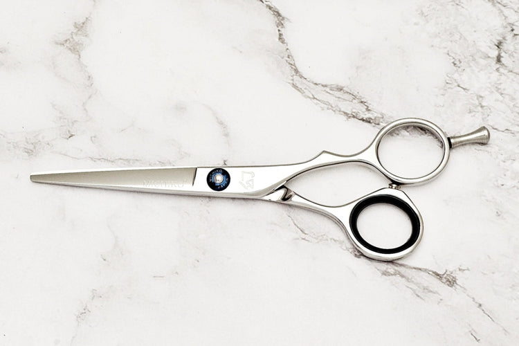 Hair cutting shears on a marble surface