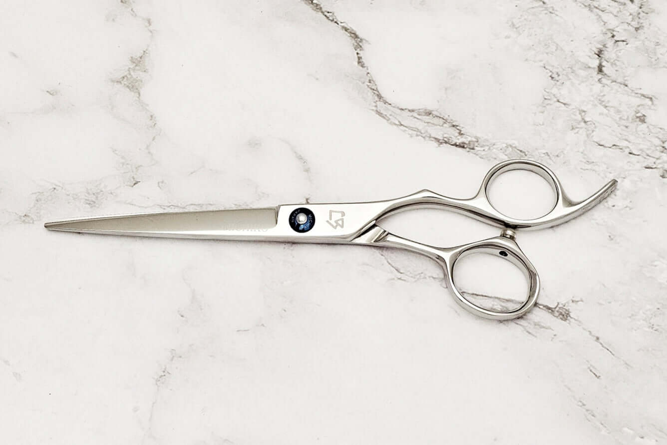 KT 6.5" barber shears on a marble surface