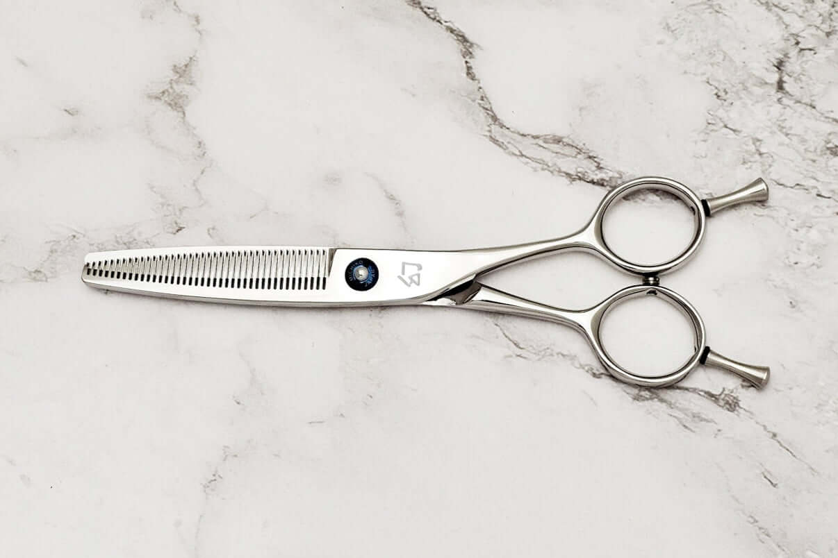 Hair thinning scissors on a marble surface