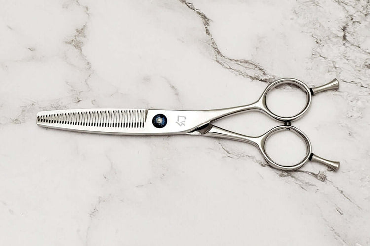 Hair thinning scissors on a marble surface