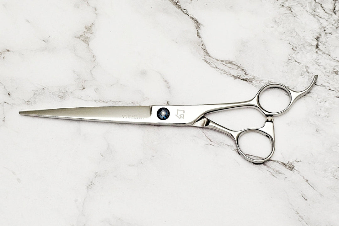 Barber shear on a white marble background