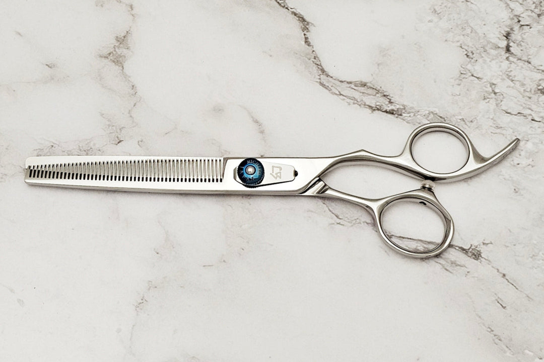 Hair cutting shears on a marble surface