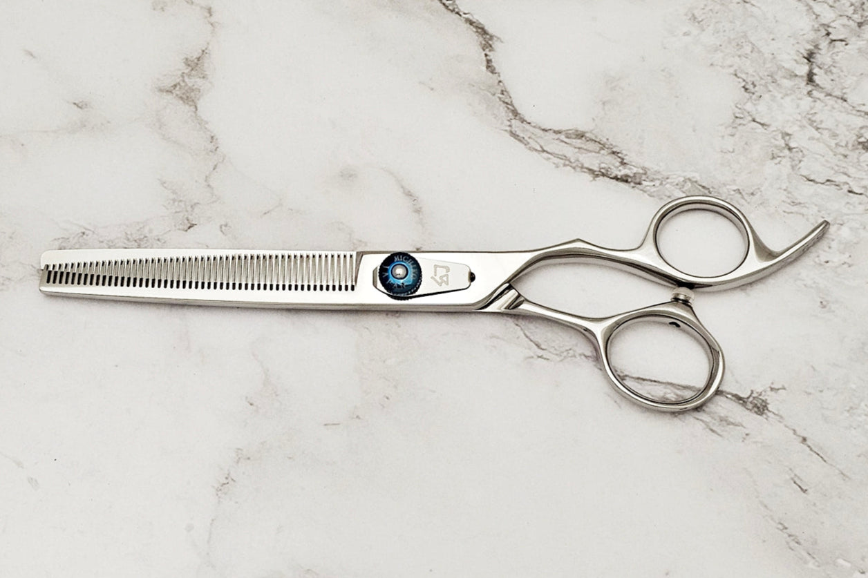 Hair cutting shears on a marble surface