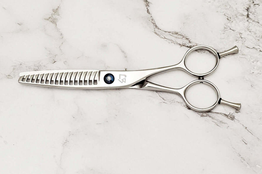 Reversible hair texturizing shears on a marble surface