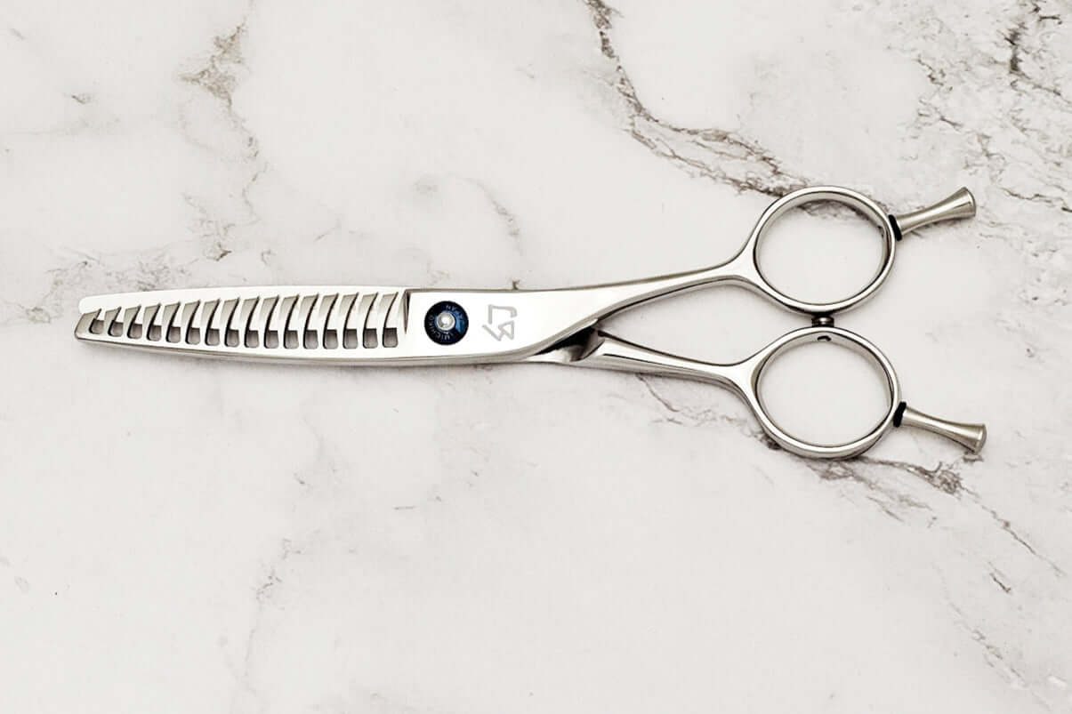 Reversible hair texturizing shears on a marble surface