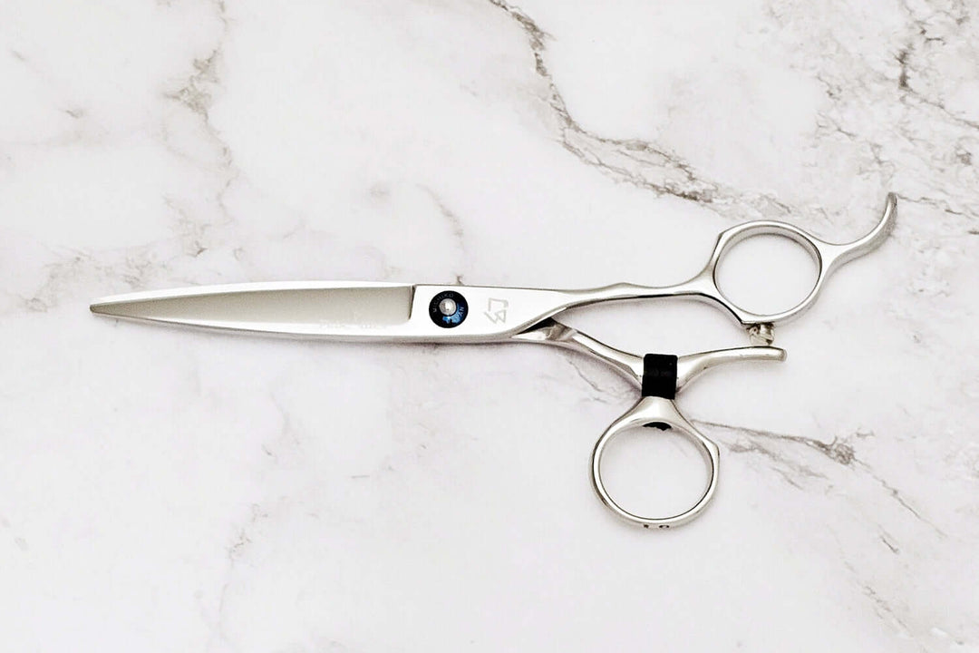 Swivel hair scissors on a marble surface