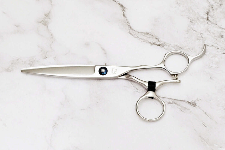 Swivel hair scissors on a marble surface