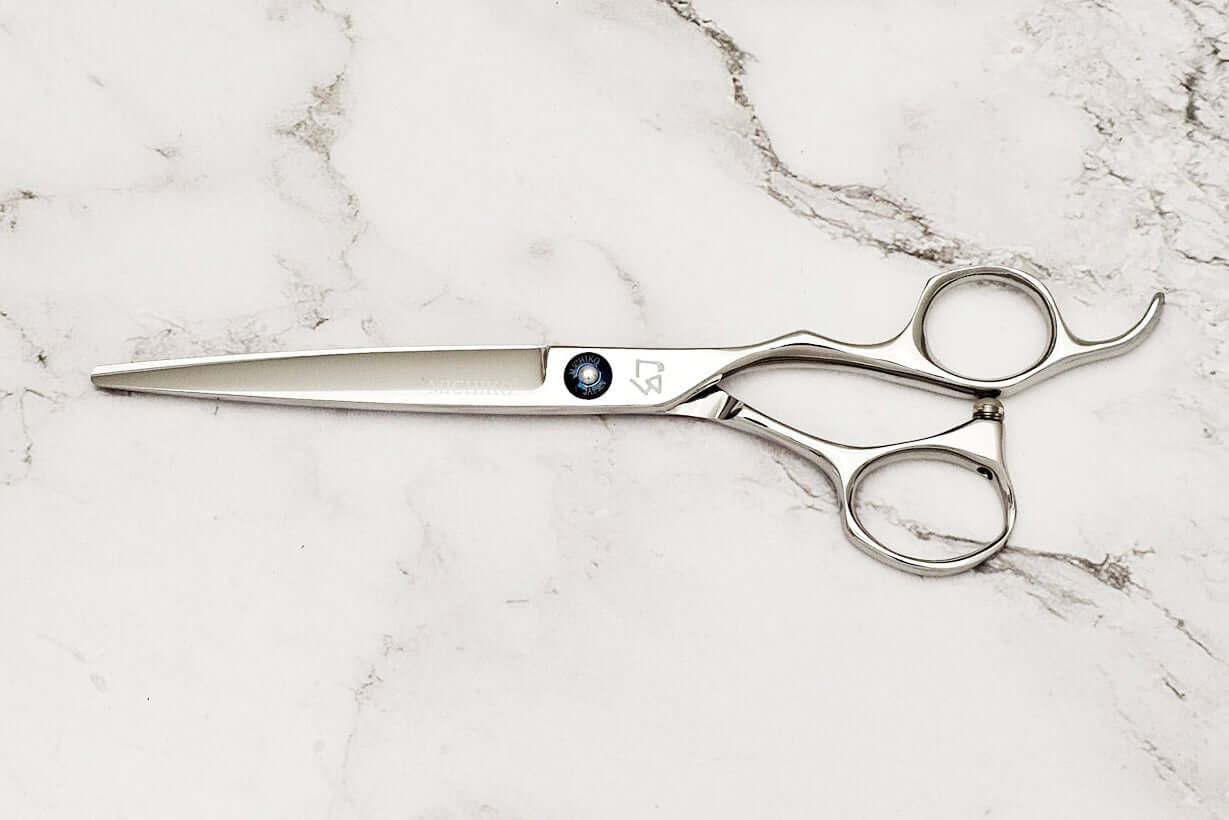 Barber scissors on a marble surface