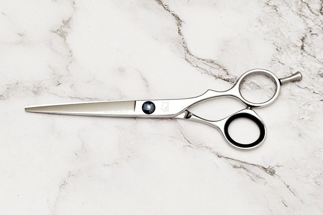 Hair cutting shears on a marble surface